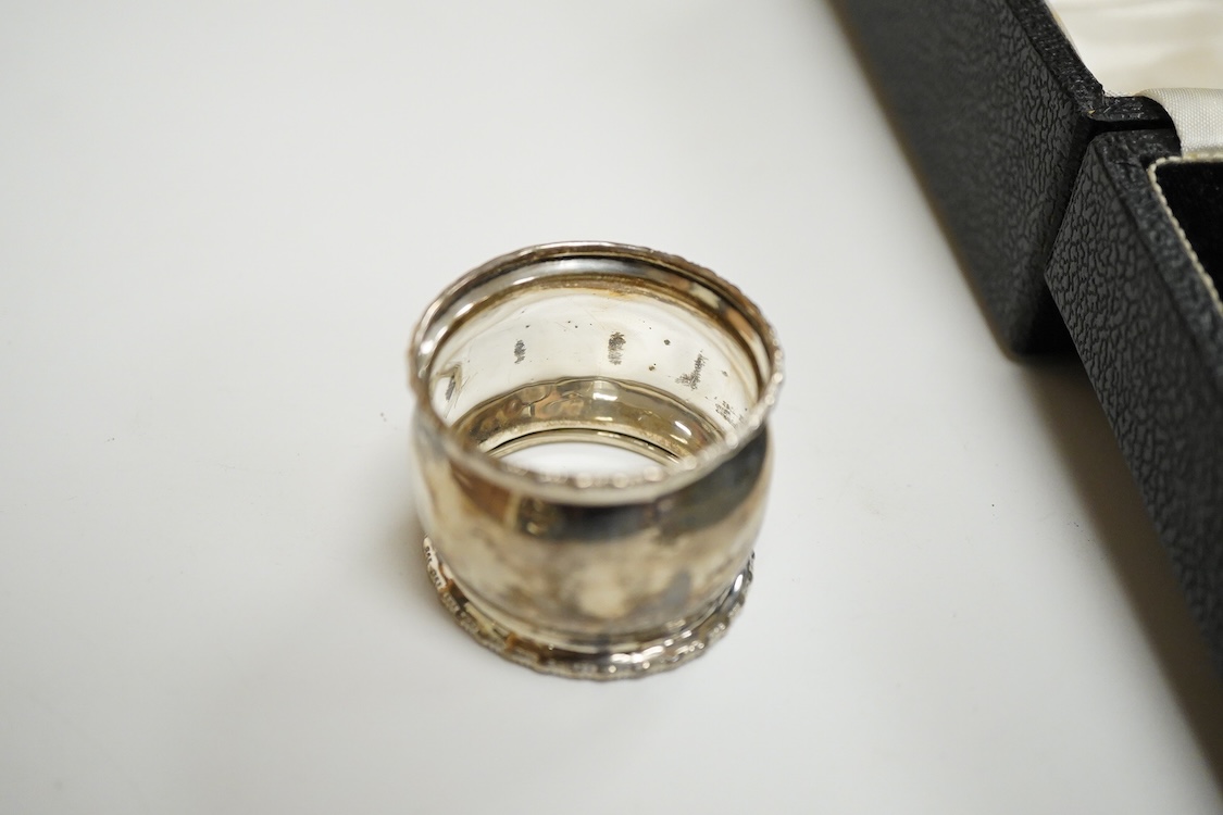 An Elizabeth II cased silver christening trio, Birmingham, 1959/60, together with three silver napkin rings.